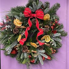 Christmas Door Wreath with cinnamon and fruits 