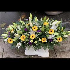 Casket spray in yellows &amp; purple 