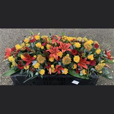 Casket spray in oranges &amp; yellows 