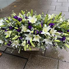 Non Allergy Lilly Casket spray with purples and foliage 