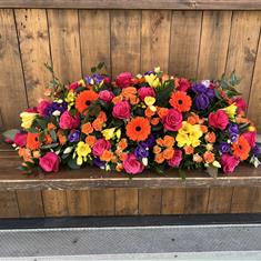 Florist choice full of colour casket spray 