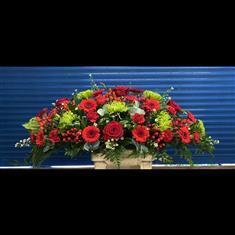 Red and green casket spray 