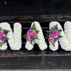 NAN TRIBUTE  MASSED IN WHITE PINk POSIES